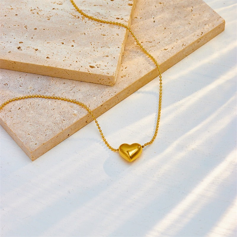 Collier cœur doré avec pierres précieuses