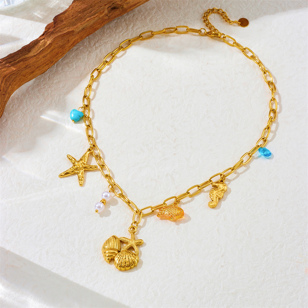 Collier pampilles doré coquillages et étoiles