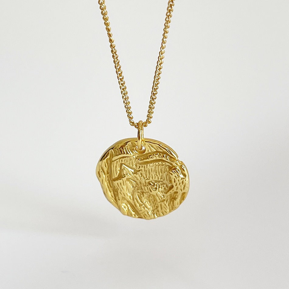 Pendentif en argent rond irrégulier